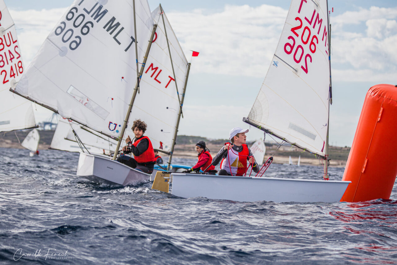 Optimist sailors rounding a mark at the Yachting Malta BSC Regatta