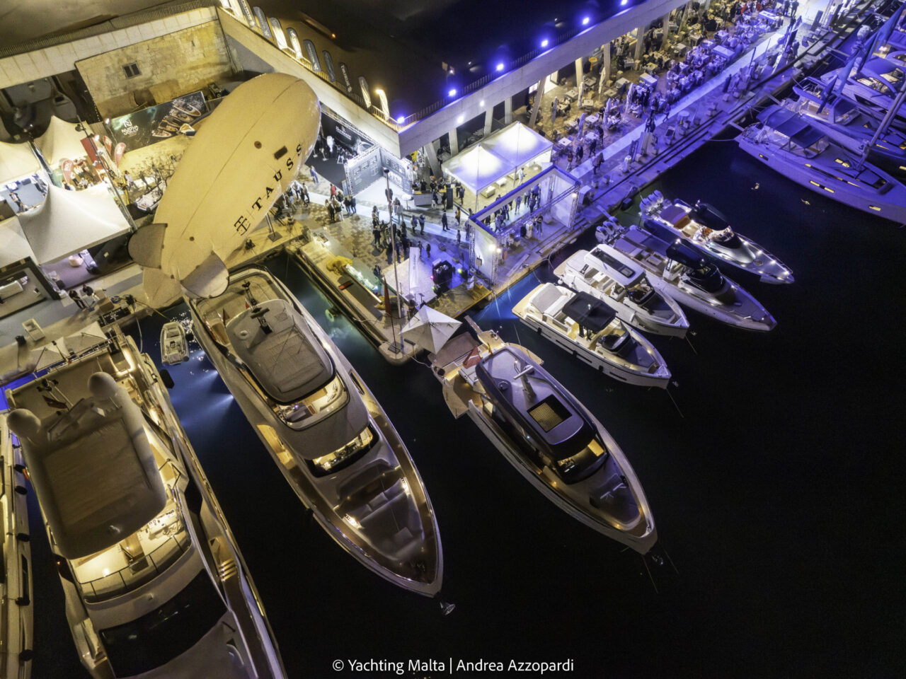 Boats berthed along Dockyard Creek at night during the Malta Boat Show