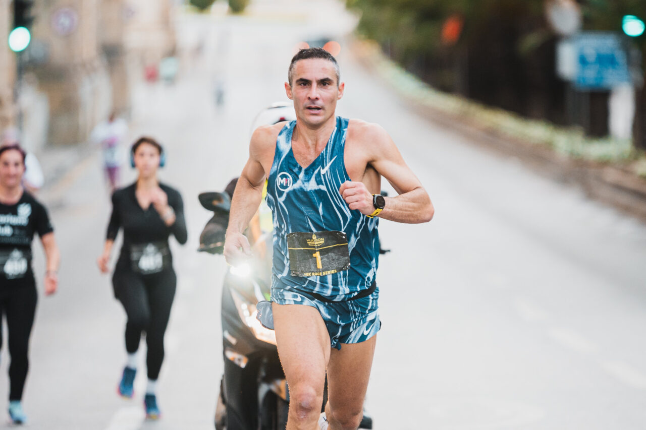 A runner leading the field on the Valletta course, December 2025